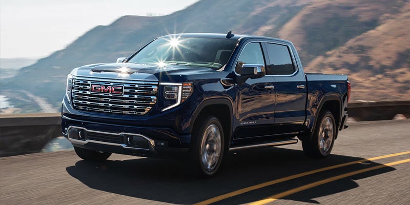2022 GMC Sierra driving in front of ocean