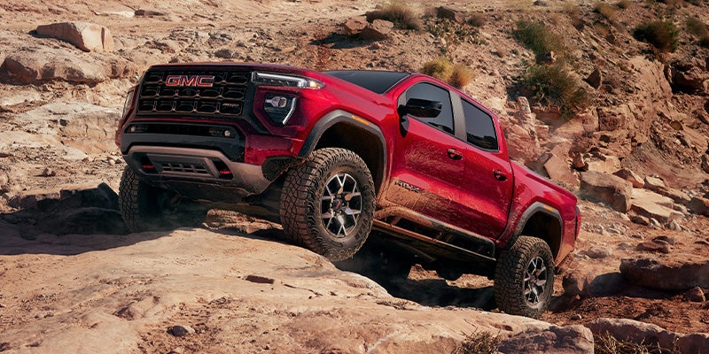 2024 GMC Canyon at Doug Henry Chevrolet GMC driving up rocks