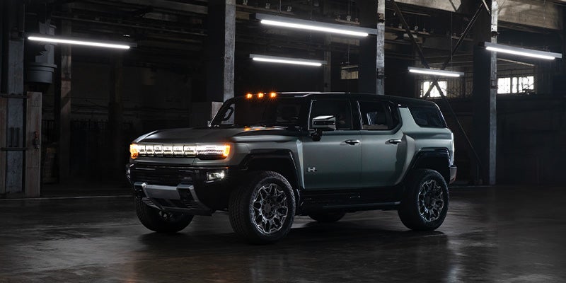 2024 GMC Hummer EV SUV at night with headlights on