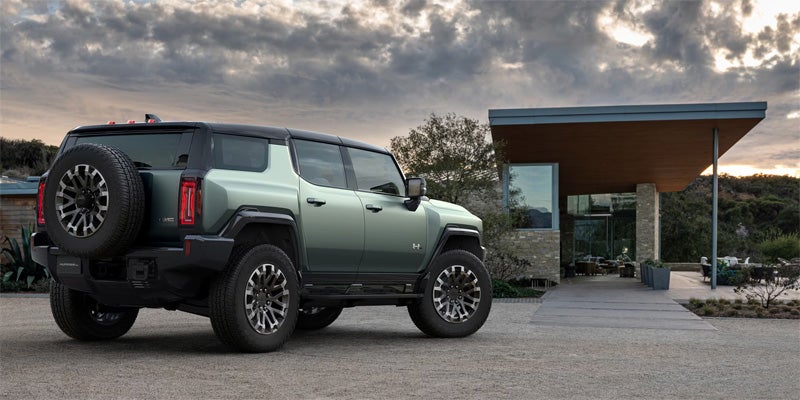 2024 GMC Hummer EV SUV parked in front of a house